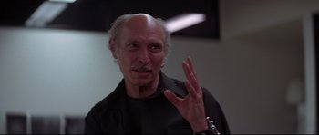 Movie still from “Escape from New York” (1981), directed by John Carpenter – An older man is making a funny face for the camera; Close Up shot, Low angle