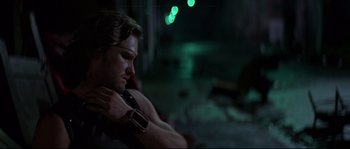 Movie still from “Escape from New York” (1981), directed by John Carpenter – A man sitting in a chair with his hands on his neck; Close Up shot, Low angle