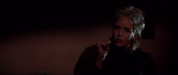 Movie still from “Escape from New York” (1981), directed by John Carpenter – A woman talking on a cell phone in the dark; Close Up shot, Low angle