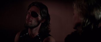 Movie still from “Escape from New York” (1981), directed by John Carpenter – A person wearing a eye patch; Close Up shot, Over the shoulder angle