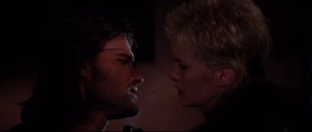 Movie still from “Escape from New York” (1981), directed by John Carpenter – A man and a woman face to face in the dark; Close Up shot, Low angle
