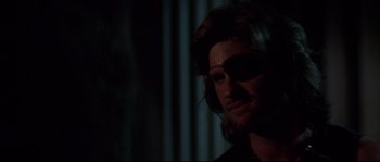 Movie still from “Escape from New York” (1981), directed by John Carpenter – A person wearing sunglasses; Close Up shot, Over the shoulder angle