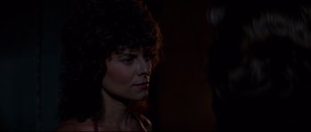 Movie still from “Escape from New York” (1981), directed by John Carpenter – A person wearing a black shirt; Close Up shot, Over the shoulder angle