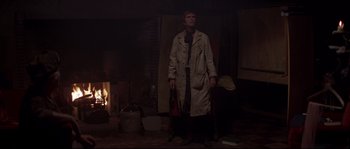 Movie still from “Escape from New York” (1981), directed by John Carpenter – A man standing in front of a fire place; Wide shot, Low angle