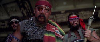 Movie still from “Escape from New York” (1981), directed by John Carpenter – A man with a beard and a red bandanna; Medium shot, Low angle