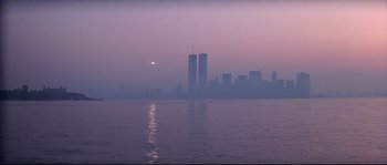 Movie still from “Escape from New York” (1981), directed by John Carpenter – A view of a city skyline from the water at dusk; Extreme Wide shot, Low angle