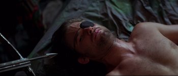 Movie still from “Escape from New York” (1981), directed by John Carpenter – A person laying on a bed; Close Up shot, High angle