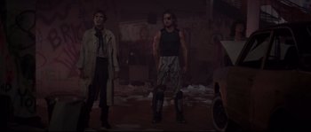 Movie still from “Escape from New York” (1981), directed by John Carpenter – Two men standing next to each other in a dark room; Wide shot, Low angle