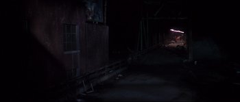 Movie still from “Escape from New York” (1981), directed by John Carpenter – A night time scene of a building and a street; Extreme Wide shot, High angle