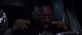 Movie still from “Escape from New York” (1981), directed by John Carpenter – A person wearing a black jacket; Close Up shot, Low angle