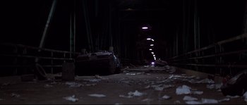 Movie still from “Escape from New York” (1981), directed by John Carpenter – A car that is sitting in the dirt; Extreme Wide shot, High angle