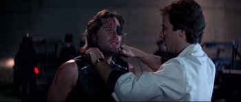 Movie still from “Escape from New York” (1981), directed by John Carpenter – A man is being examined by a doctor; Close Up shot, Low angle