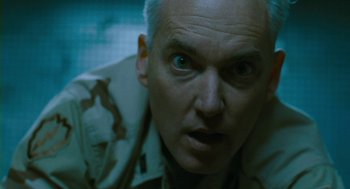 Movie still from “Essential Killing” (2010), directed by Jerzy Skolimowski – A man's face in a military uniform; Close Up shot, Low angle