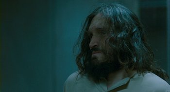 Movie still from “Essential Killing” (2010), directed by Jerzy Skolimowski – A man with long hair and a long beard; Close Up shot, Over the shoulder angle