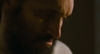 Movie still from “Essential Killing” (2010), directed by Jerzy Skolimowski – A person with a beard; Extreme Close Up shot, Low angle