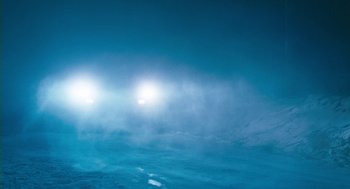 Movie still from “Essential Killing” (2010), directed by Jerzy Skolimowski – The sun is shining through the clouds in the night sky; Extreme Wide shot, Low angle