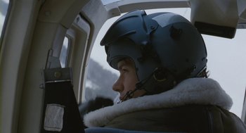 Movie still from “Essential Killing” (2010), directed by Jerzy Skolimowski – A person wearing a helmet in the cockpit of an airplane; Close Up shot, Low angle
