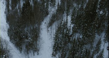 Movie still from “Essential Killing” (2010), directed by Jerzy Skolimowski – A person is skiing down a snowy slope; Extreme Wide shot, High angle