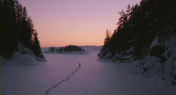 Movie still from “Essential Killing” (2010), directed by Jerzy Skolimowski – A person walking across a snow covered field; Extreme Wide shot, High angle