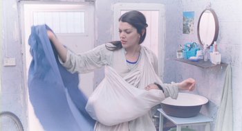 Movie still from “Essential Killing” (2010), directed by Jerzy Skolimowski – A woman holding a baby wrapped in a sling; Medium shot, Low angle