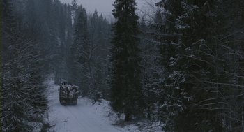 Movie still from “Essential Killing” (2010), directed by Jerzy Skolimowski – A truck driving down a road in the snow; Extreme Wide shot, High angle