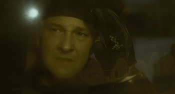 Movie still from “Essential Killing” (2010), directed by Jerzy Skolimowski – A person looking through a window; Close Up shot, Low angle