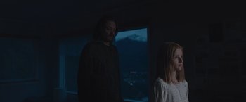 Movie still from “The Quake” (2018), directed by John Andreas Andersen – A man and a woman standing in front of a window at night; Medium shot, Low angle