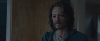 Movie still from “The Quake” (2018), directed by John Andreas Andersen – A person with long hair; Close Up shot, Over the shoulder angle