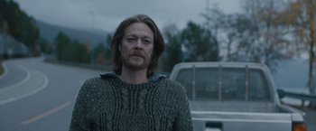Movie still from “The Quake” (2018), directed by John Andreas Andersen – A man with long hair wearing a sweater; Medium shot, Over the shoulder angle