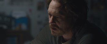 Movie still from “The Quake” (2018), directed by John Andreas Andersen – A person with long hair and a beard; Close Up shot, Over the shoulder angle