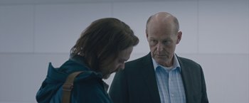Movie still from “The Quake” (2018), directed by John Andreas Andersen – A man and a woman standing next to each other in a room; Close Up shot, Over the shoulder angle