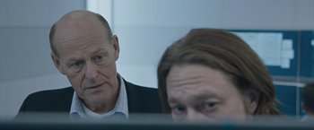 Movie still from “The Quake” (2018), directed by John Andreas Andersen – A man and a woman looking at a computer screen; Close Up shot, Over the shoulder angle