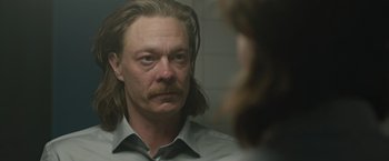 Movie still from “The Quake” (2018), directed by John Andreas Andersen – A man with long hair looking into a mirror; Close Up shot, Over the shoulder angle