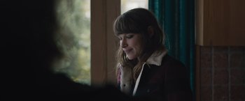 Movie still from “The Quake” (2018), directed by John Andreas Andersen – A woman with long brown hair wearing a brown jacket; Close Up shot, Over the shoulder angle