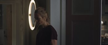 Movie still from “The Quake” (2018), directed by John Andreas Andersen – A woman standing in front of a mirror; Medium shot, Over the shoulder angle