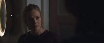 Movie still from “The Quake” (2018), directed by John Andreas Andersen – A person wearing a black shirt; Close Up shot, Over the shoulder angle