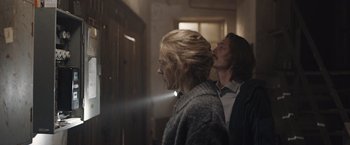 Movie still from “The Quake” (2018), directed by John Andreas Andersen – A man and a woman standing next to each other in a room; Medium shot, Over the shoulder angle