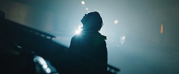 Movie still from “The Quake” (2018), directed by John Andreas Andersen – A person standing in the middle of the night with the sun shining; Extreme Close Up shot, Low angle