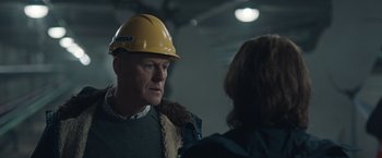 Movie still from “The Quake” (2018), directed by John Andreas Andersen – An older man wearing a hard hat talking to an older woman; Close Up shot, Low angle