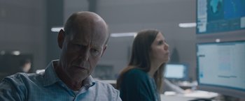 Movie still from “The Quake” (2018), directed by John Andreas Andersen – A man and a woman sitting next to each other in front of a computer monitor; Close Up shot, Over the shoulder angle