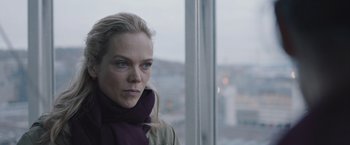 Movie still from “The Quake” (2018), directed by John Andreas Andersen – A woman in a purple scarf looking out of a window; Close Up shot, Over the shoulder angle