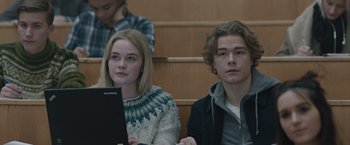 Movie still from “The Quake” (2018), directed by John Andreas Andersen – A man and a woman sitting next to each other in front of a computer; Medium shot, Low angle