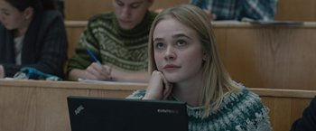Movie still from “The Quake” (2018), directed by John Andreas Andersen – A young woman sitting in front of a laptop computer; Close Up shot, Low angle