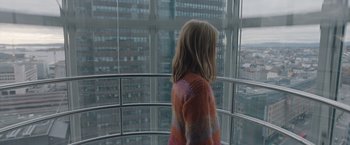 Movie still from “The Quake” (2018), directed by John Andreas Andersen – A little girl standing in front of a large window; Medium shot, High angle