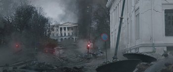 Movie still from “The Quake” (2018), directed by John Andreas Andersen – Smoke billows from a building in the background; Extreme Wide shot, Low angle