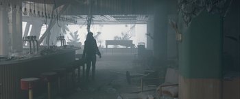 Movie still from “The Quake” (2018), directed by John Andreas Andersen – A person standing in a room in the middle of a room; Wide shot, Low angle