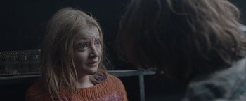 Movie still from “The Quake” (2018), directed by John Andreas Andersen – A girl with a sad look on her face looking in the mirror; Close Up shot, Over the shoulder angle