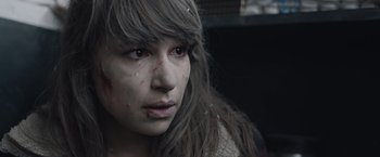 Movie still from “The Quake” (2018), directed by John Andreas Andersen – A young woman with long brown hair and red eyes; Close Up shot, Over the shoulder angle