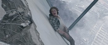 Movie still from “The Quake” (2018), directed by John Andreas Andersen – A man leaning up against a window ledge; Medium shot, Overhead angle