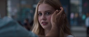 Movie still from “Every Day” (2018), directed by Michael Sucsy – A young woman is looking at the camera while holding her hair; Close Up shot, Over the shoulder angle
